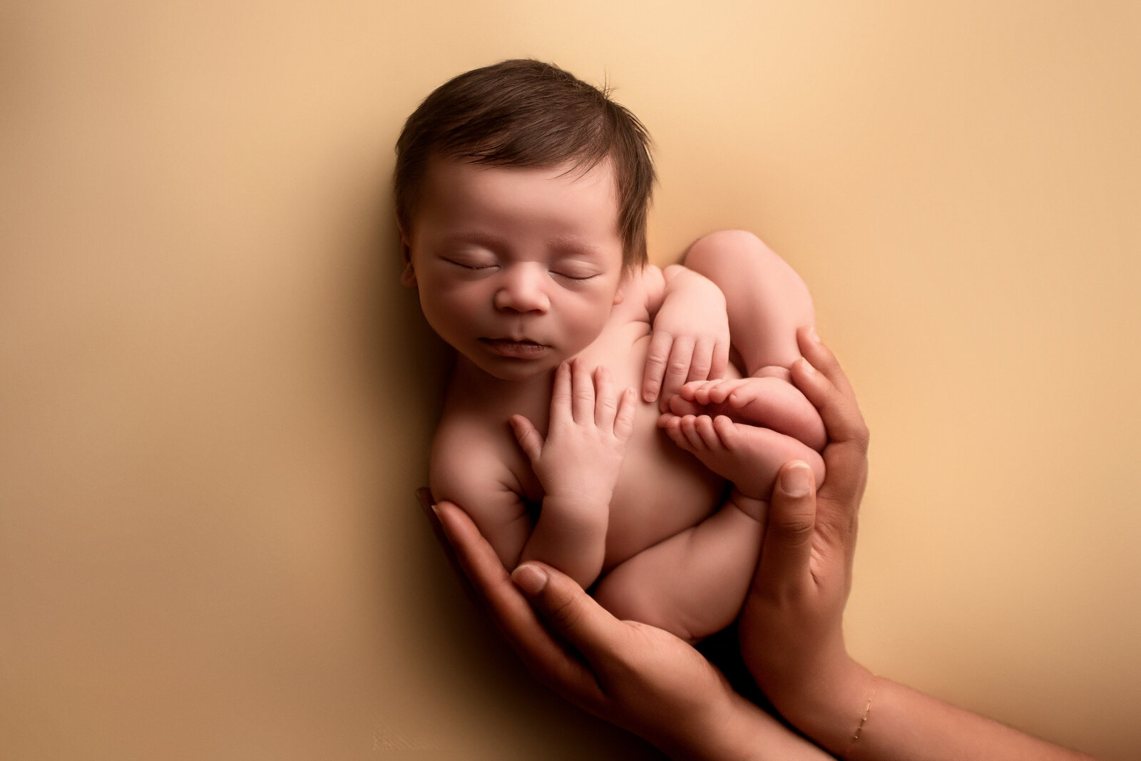 baby in moms hands during newborn session. sacramento, california newborn photographer