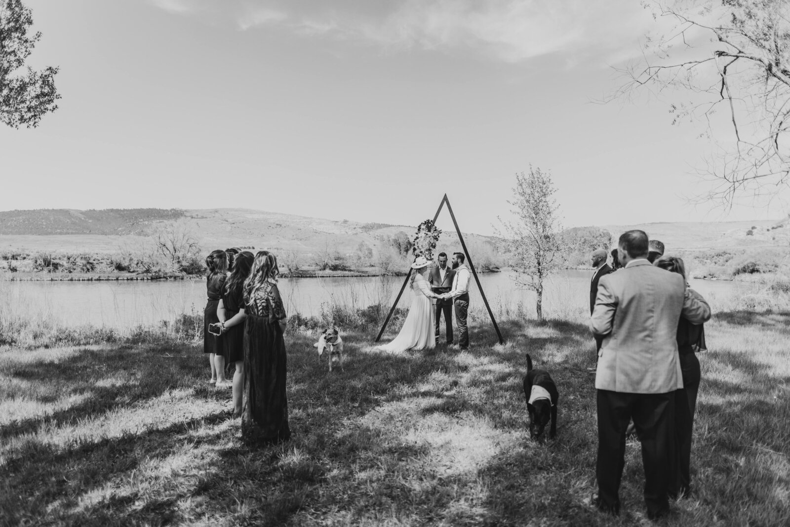 landscape shot of ceremony along river