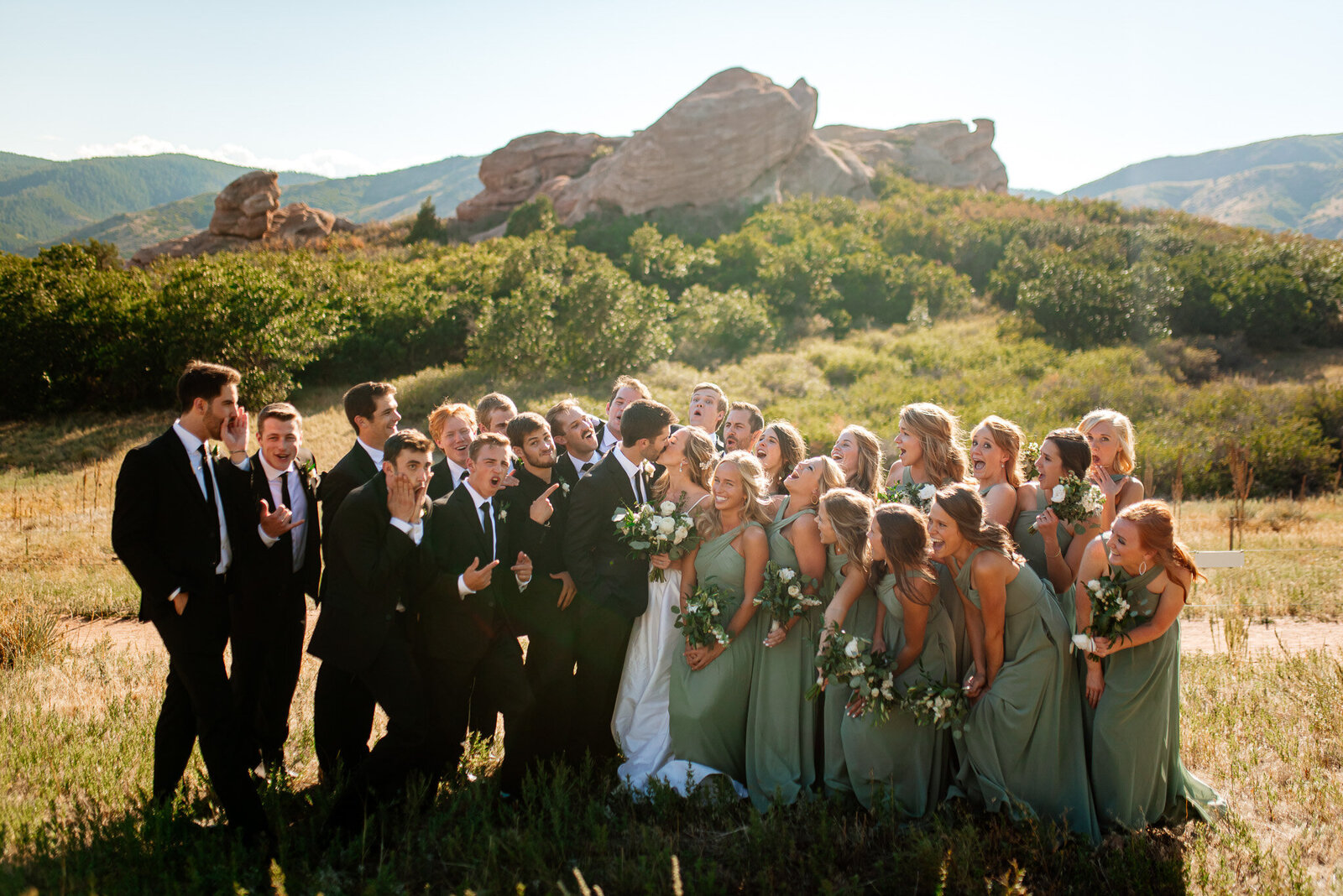 Large bridal party candid photo of everyone together at Red Rocks in Colorado.