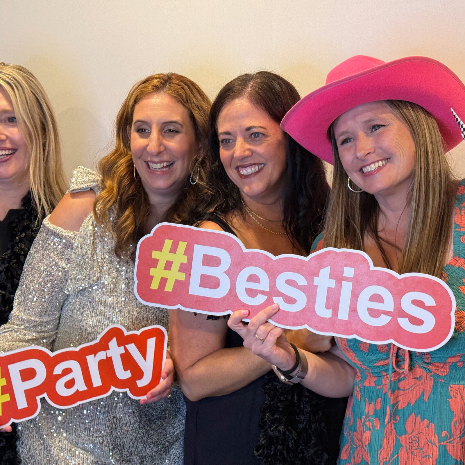 group of women taking a photo in photo booth