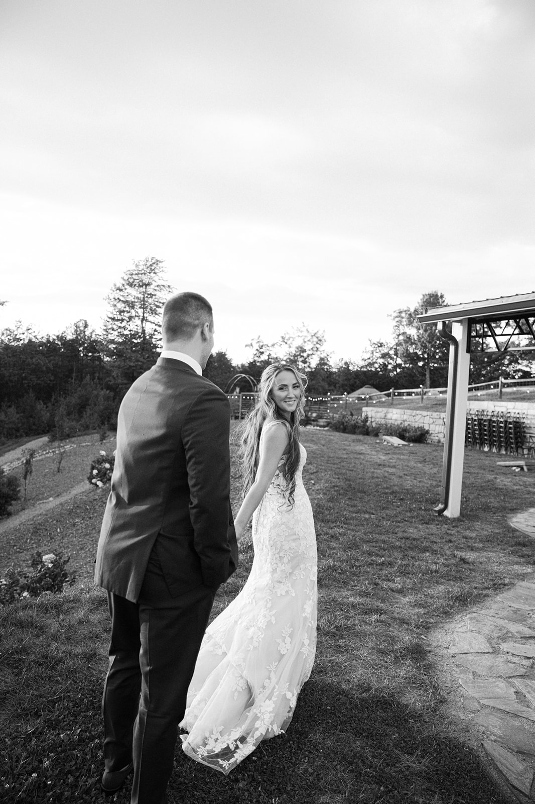 Recently married couple walking outside their wedding venue | Megan Smith Photography