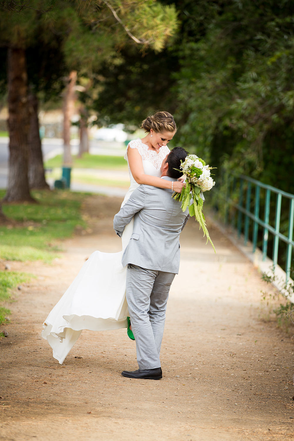 groom swinging bride around