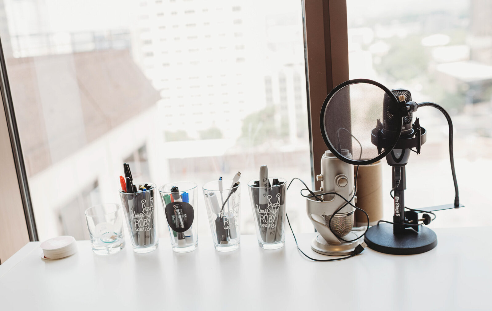 Branding Photographer,  Podcast mike on a table with office supplies facing window