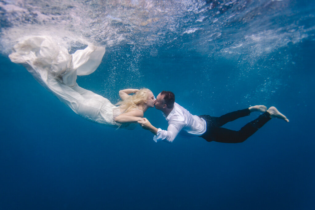 gorgeous underwater portrait of bride and groom