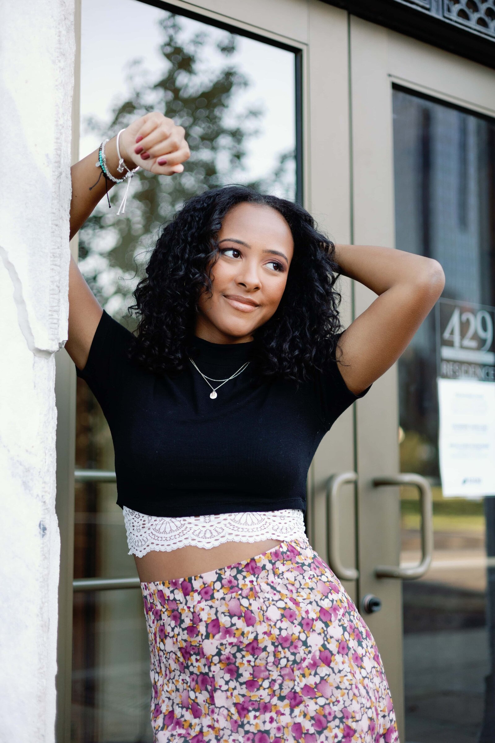 Urban lifestyle senior photo of girl with black top and floral skirt
