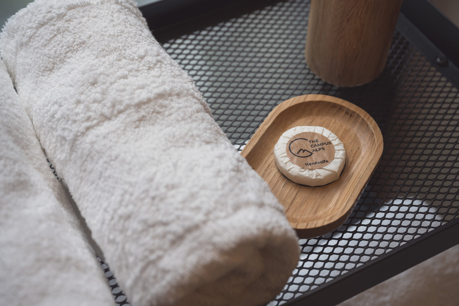 Towels and soap neatly arranged in a Tiny Home room at The Campus Alps.com, offering comfortable and convenient amenities for private getaways and company retreats in the Alps.