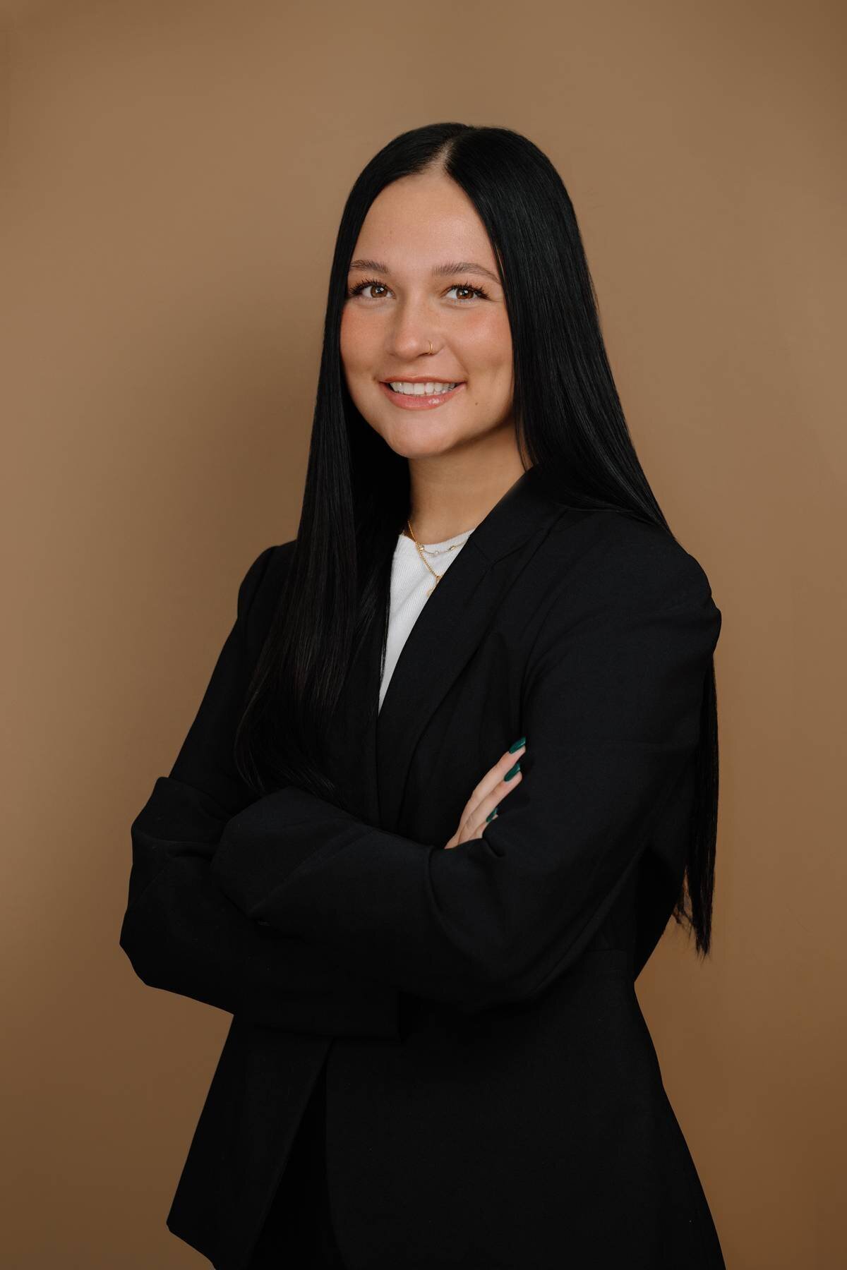 Professional headshot of a woman business owner taken in a studio setting, projecting confidence and leadership