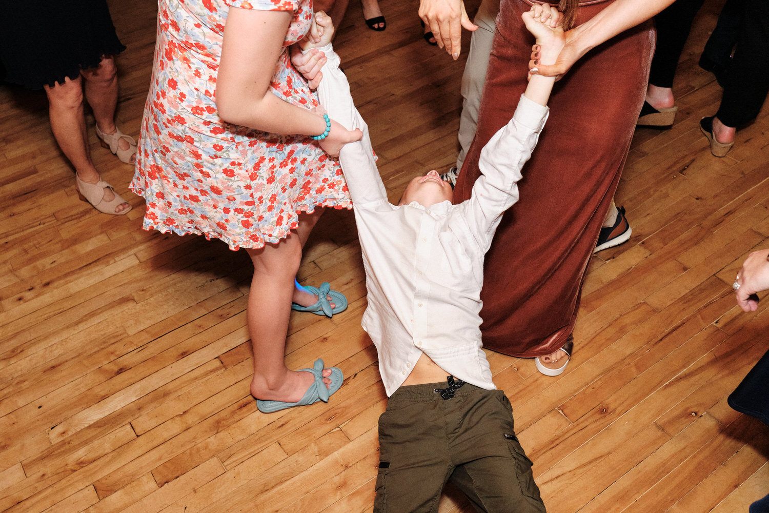 Young wedding guest dragged off the dance floor.
