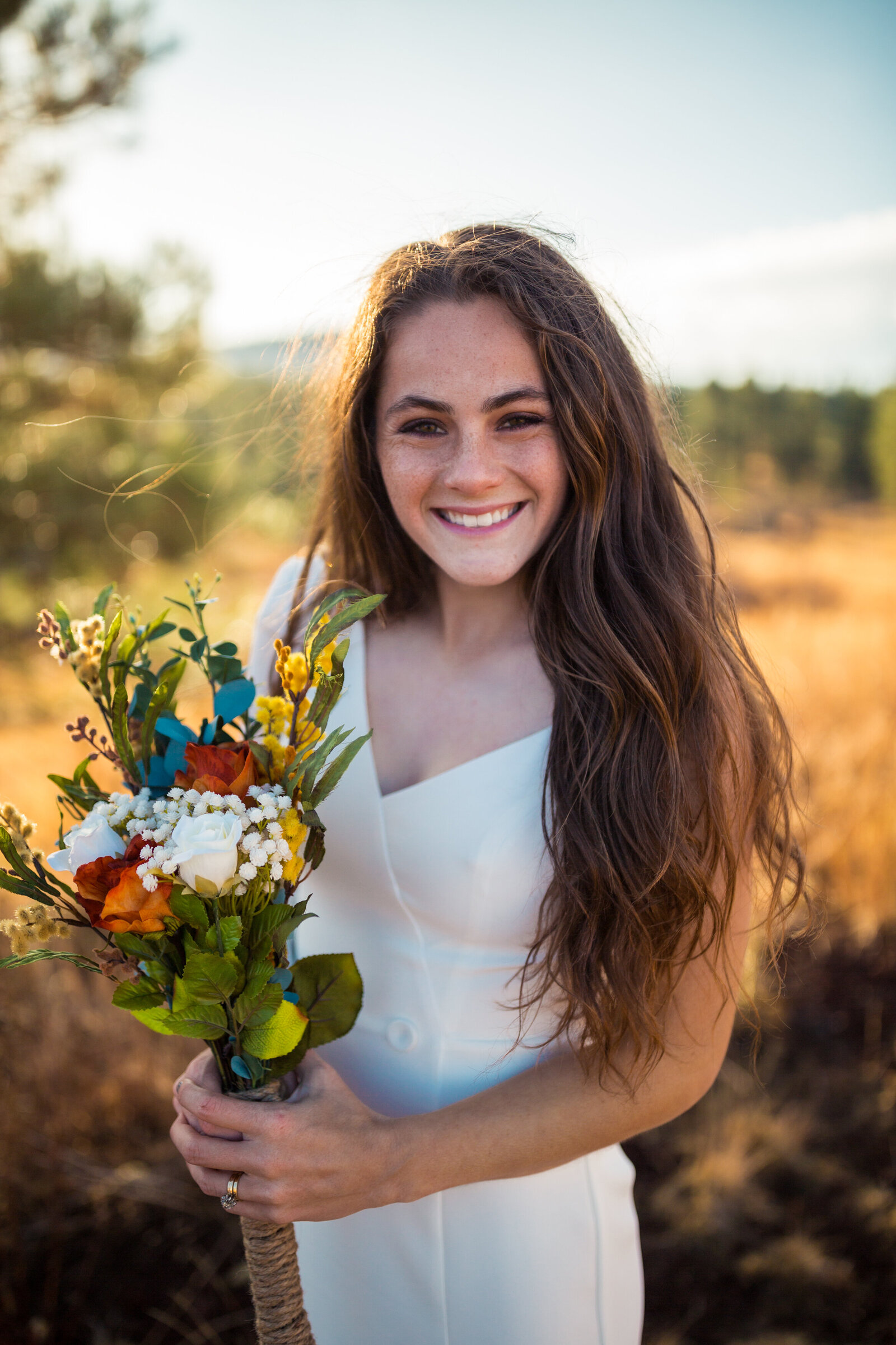 bride in flagstaff, arizona holding colorful dried bouquet