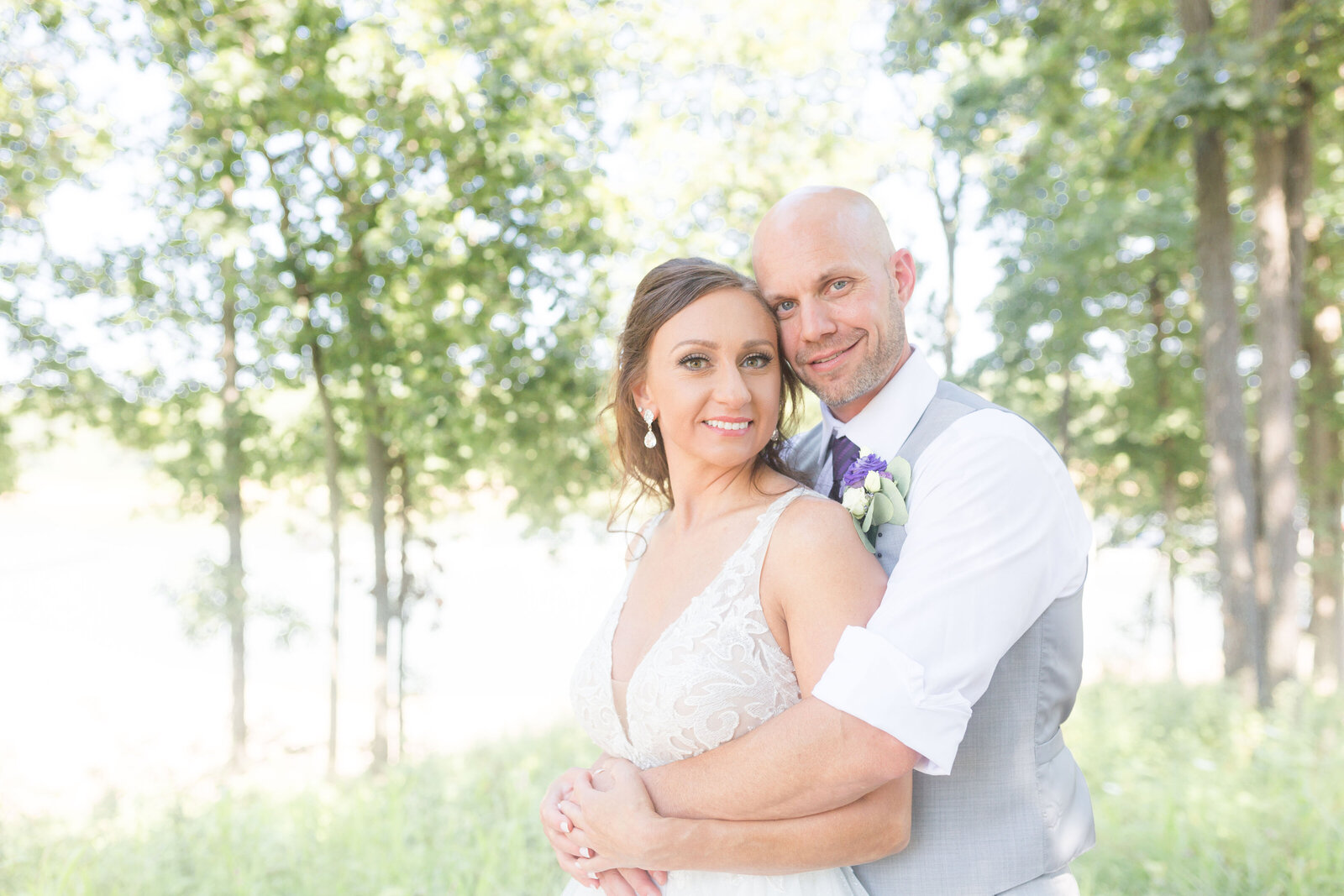 groom embraces bride at Honey Creek Resort