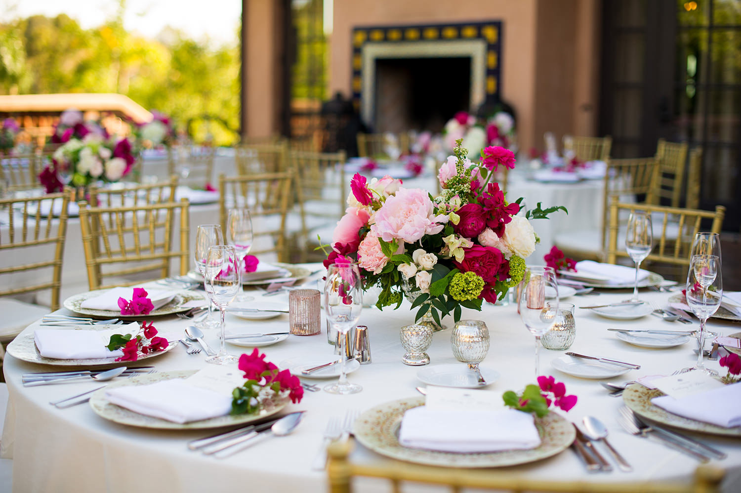 Delightful use of florals and color to make this reception table setting shine