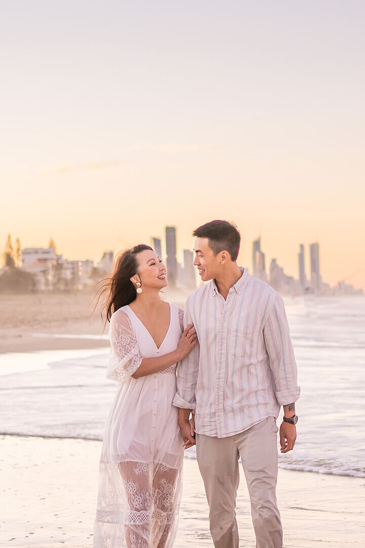 couple on miami beach enjoying their engagement photoshoot in pastel sunset