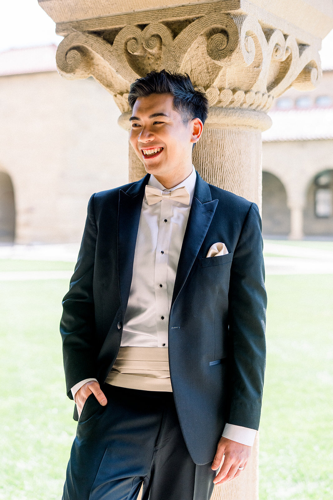 A candid moment of the groom in a thoughtful pose, highlighting his anticipation and excitement at Stanford University.