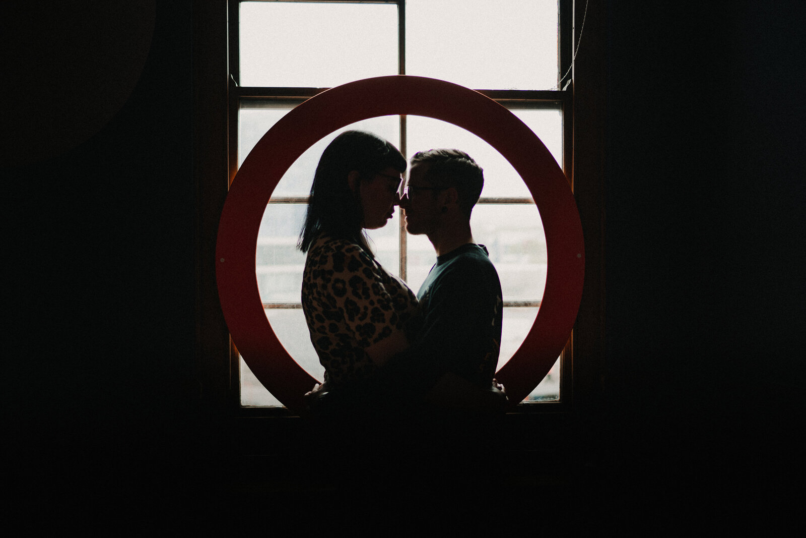 Silhouette shot of a couple against a window. Creative alternative photography