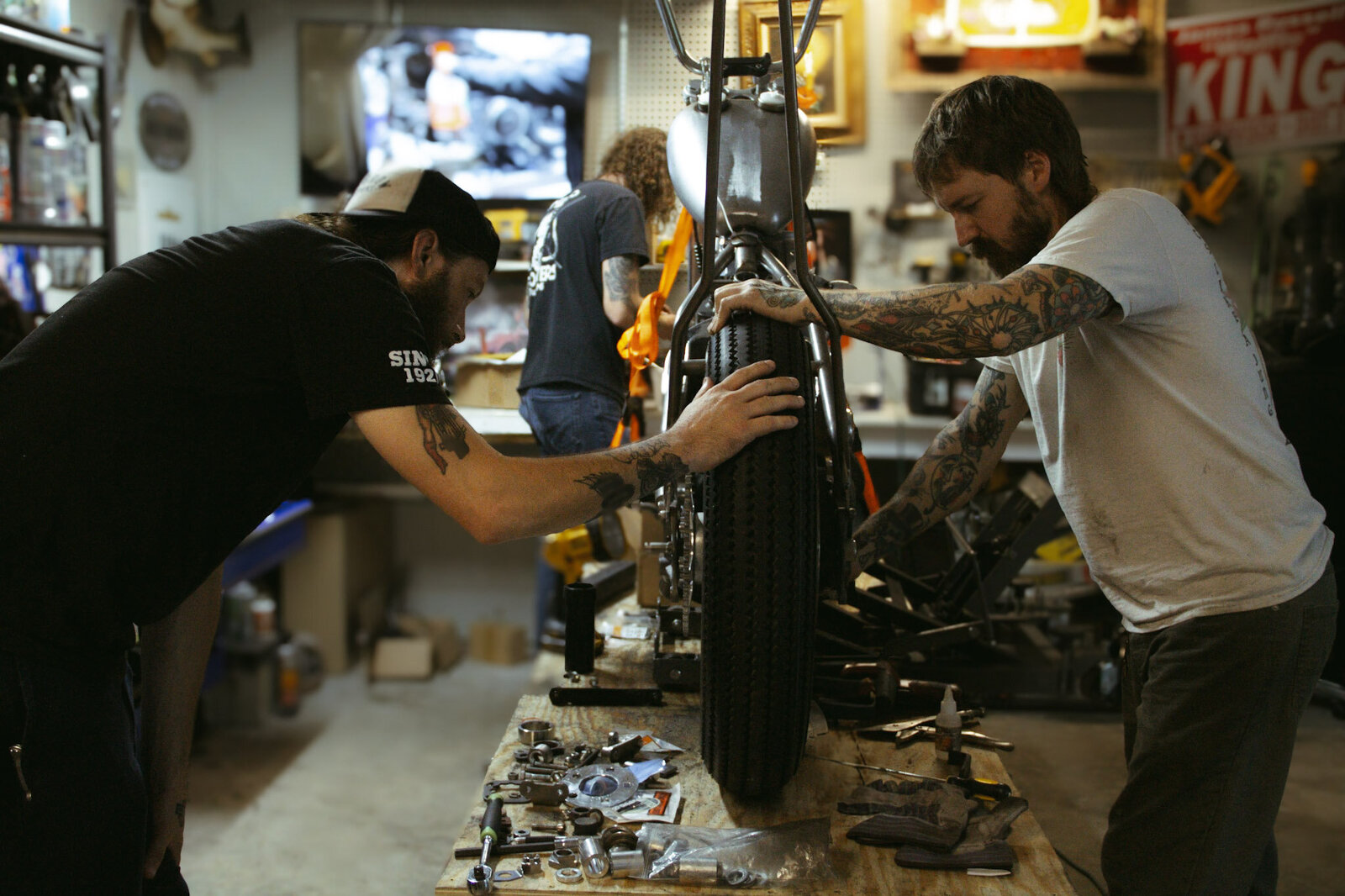 Harley techs working on a softail