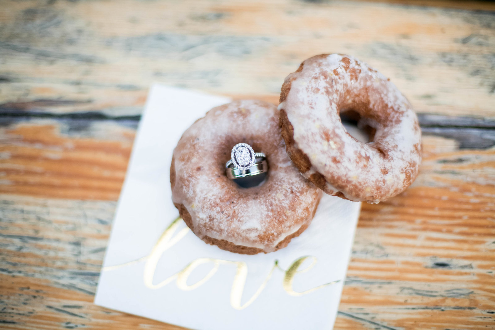 Wedding rings sitting in a donut.