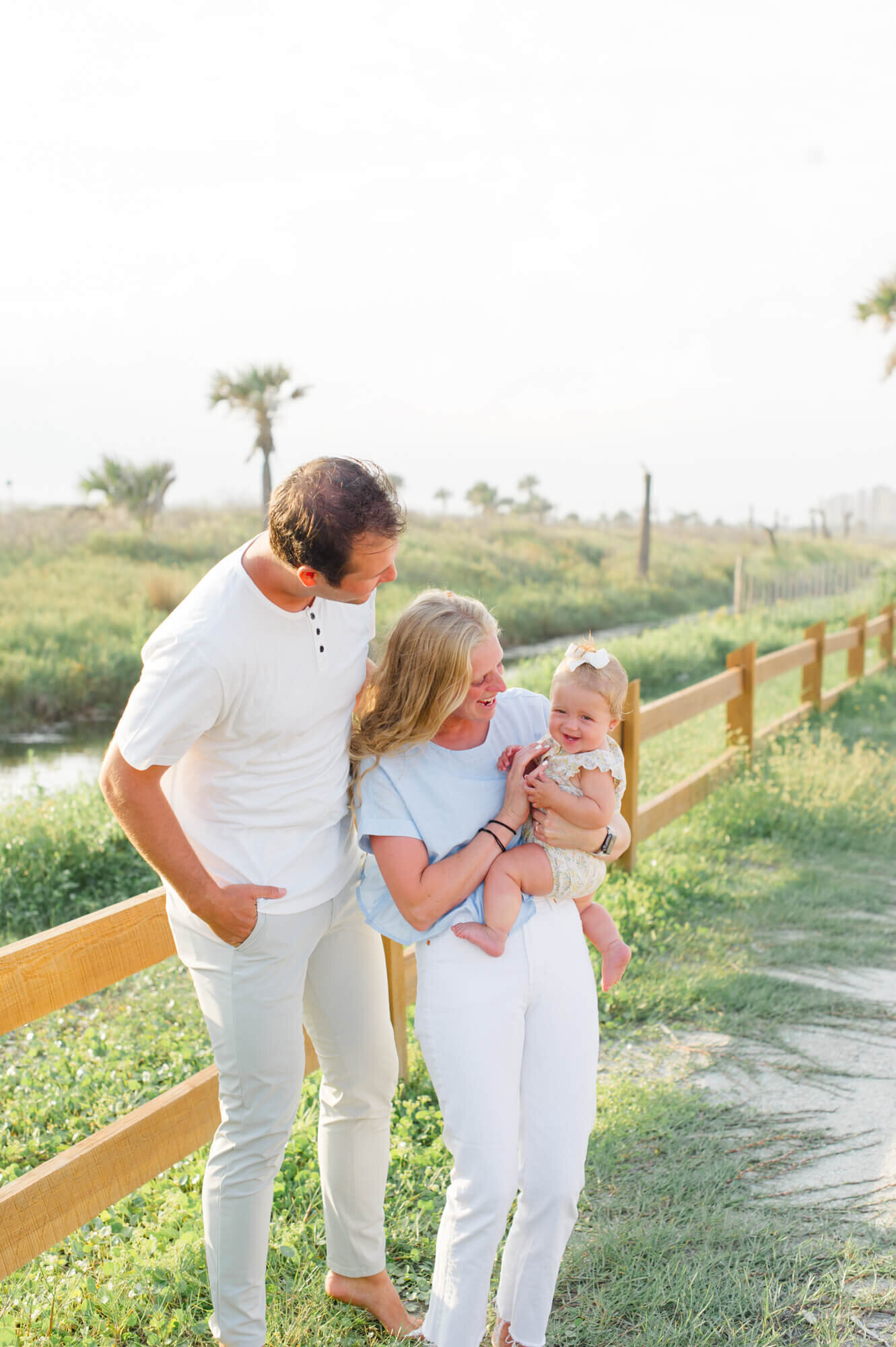 Vero Beach family photographer captures family tickling young daughter near Vero Beach