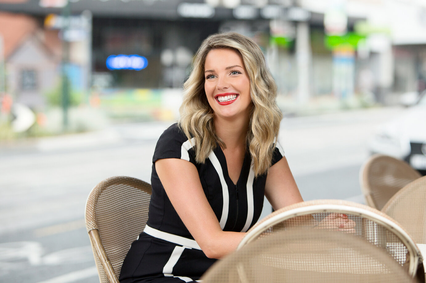 Business woman sitting at a cafe table smiling
