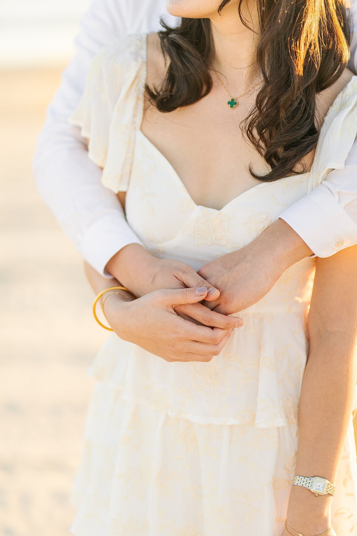 Groom holding bride on the sandy beaches of Coronado Island.