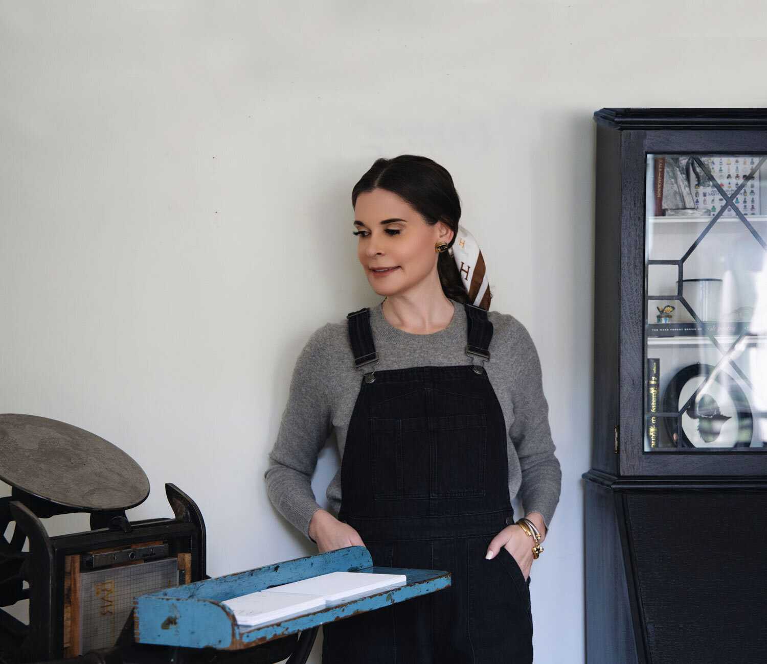 Erin Eileen, a calligrapher, standing by a letterpress tray