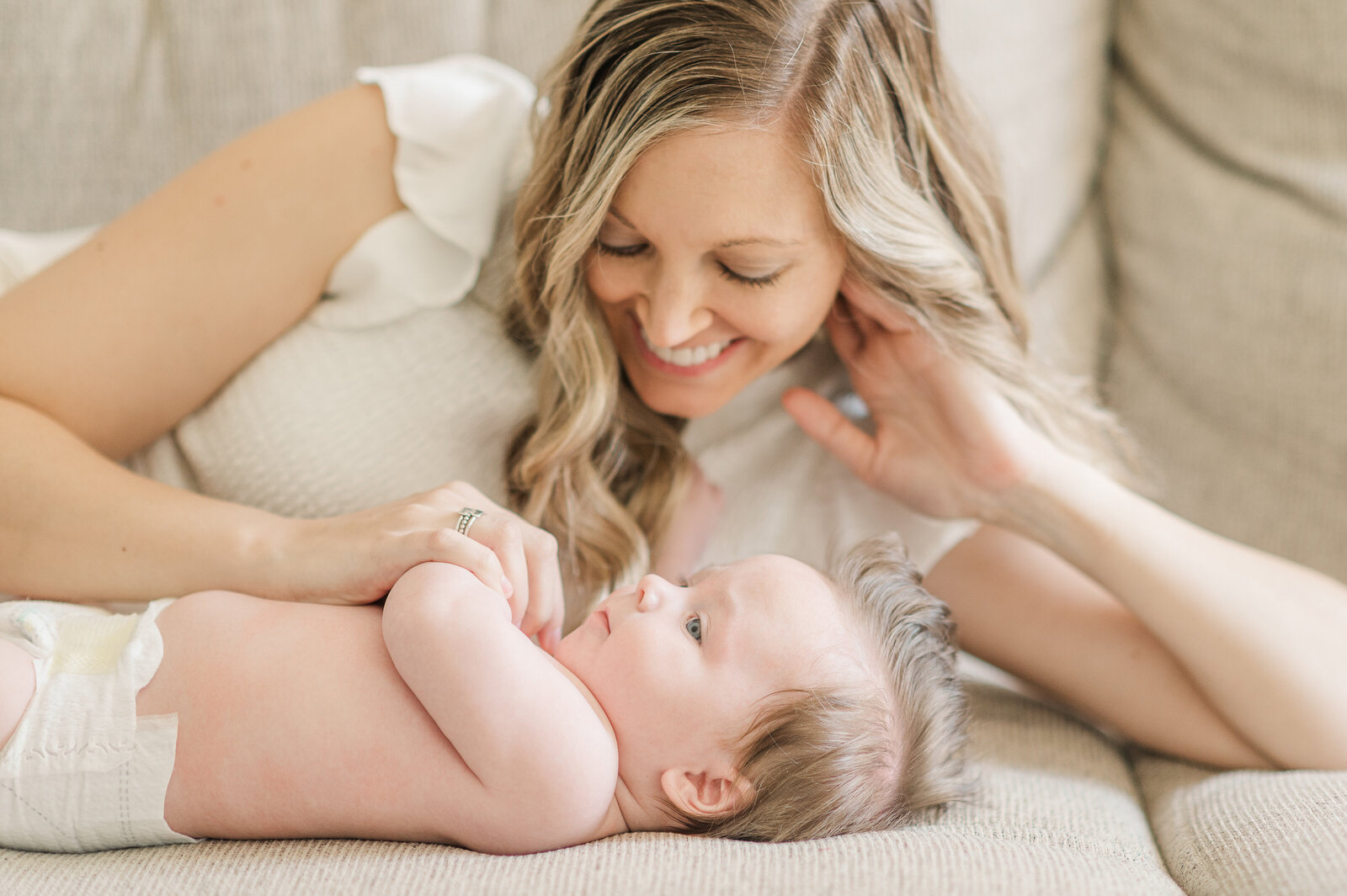 mother laying with baby boy on the couch by york pa photographer