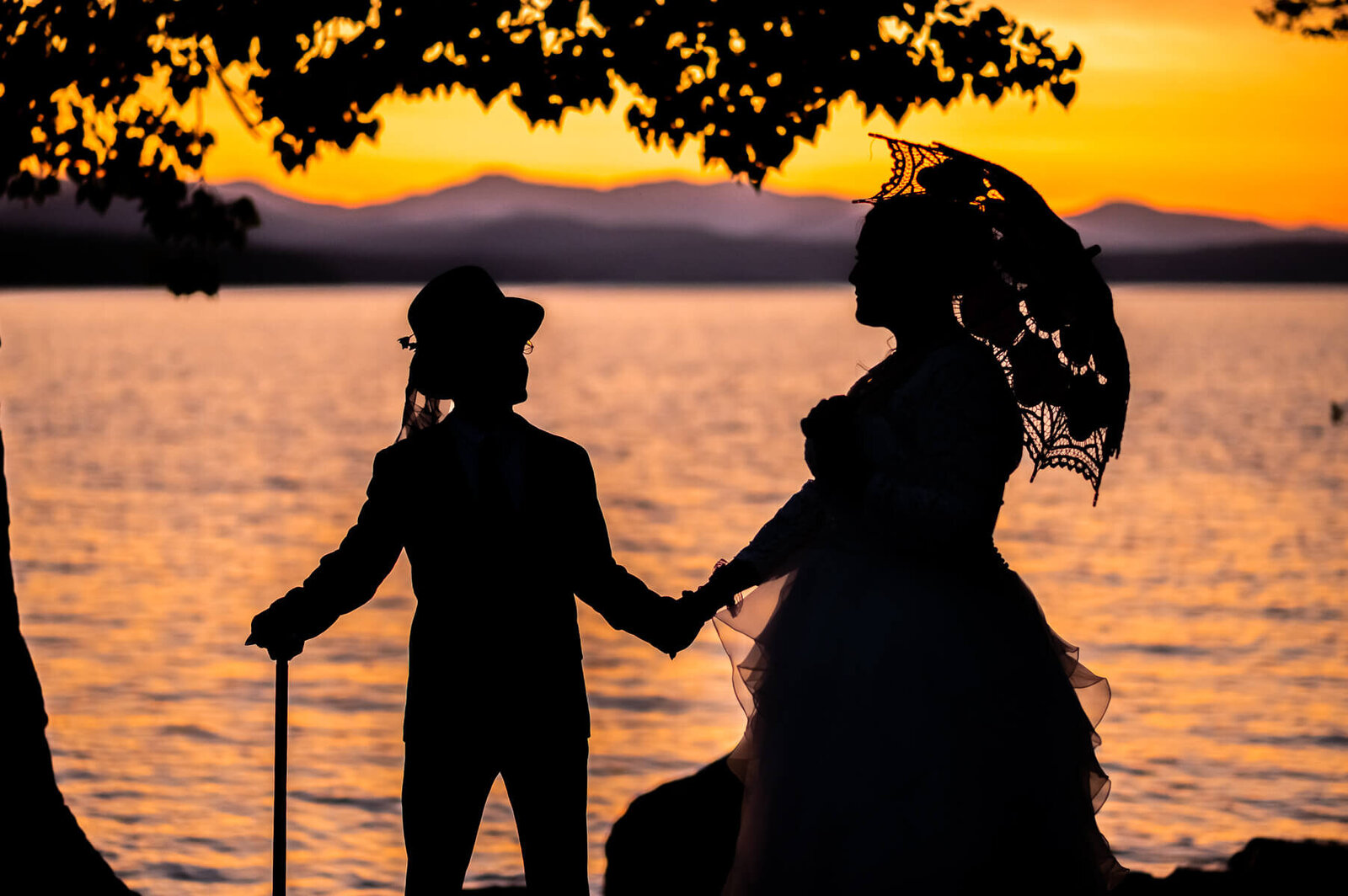 silhouette of couple on lake champlain