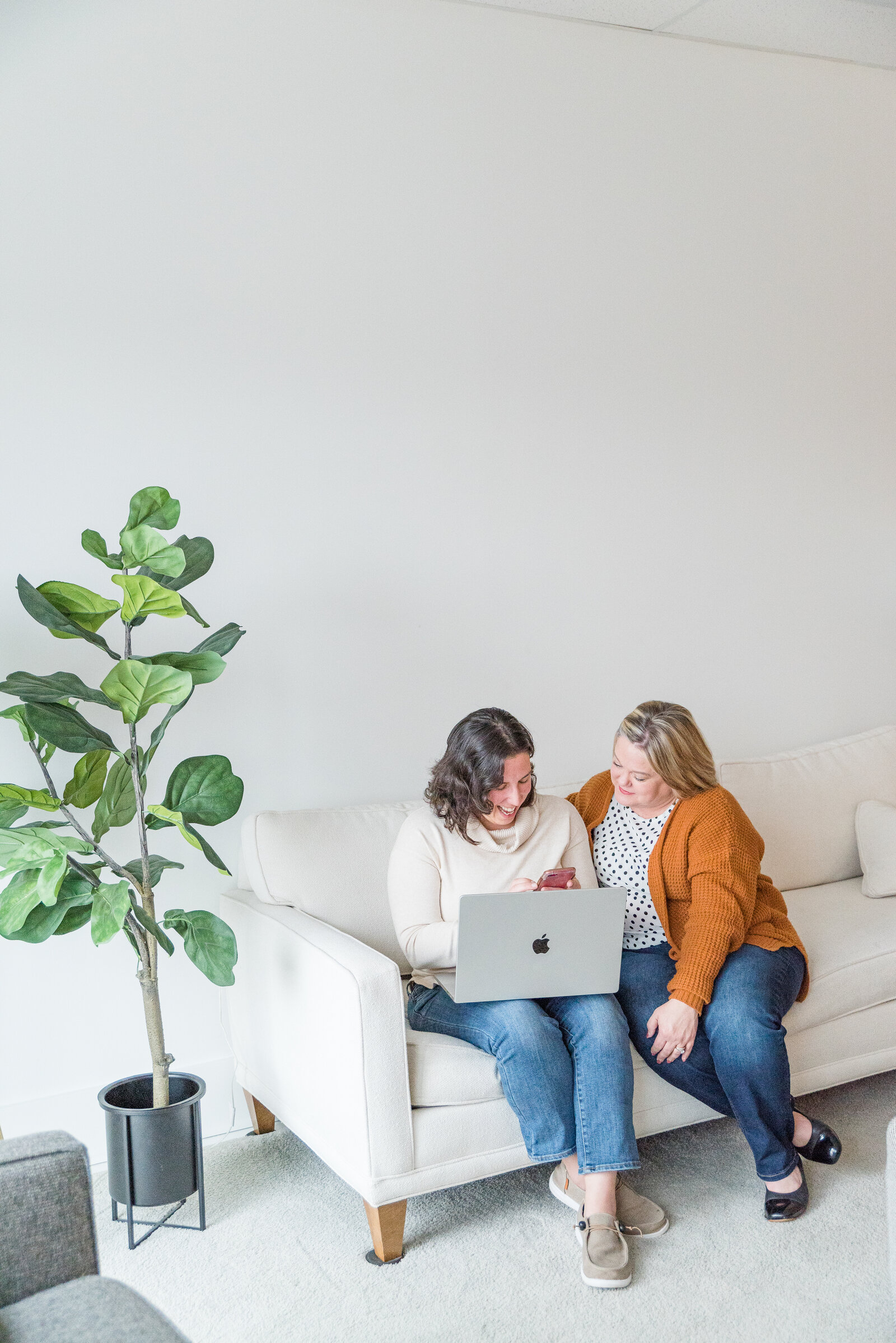 Man and woman looking at laptop with camera on the table