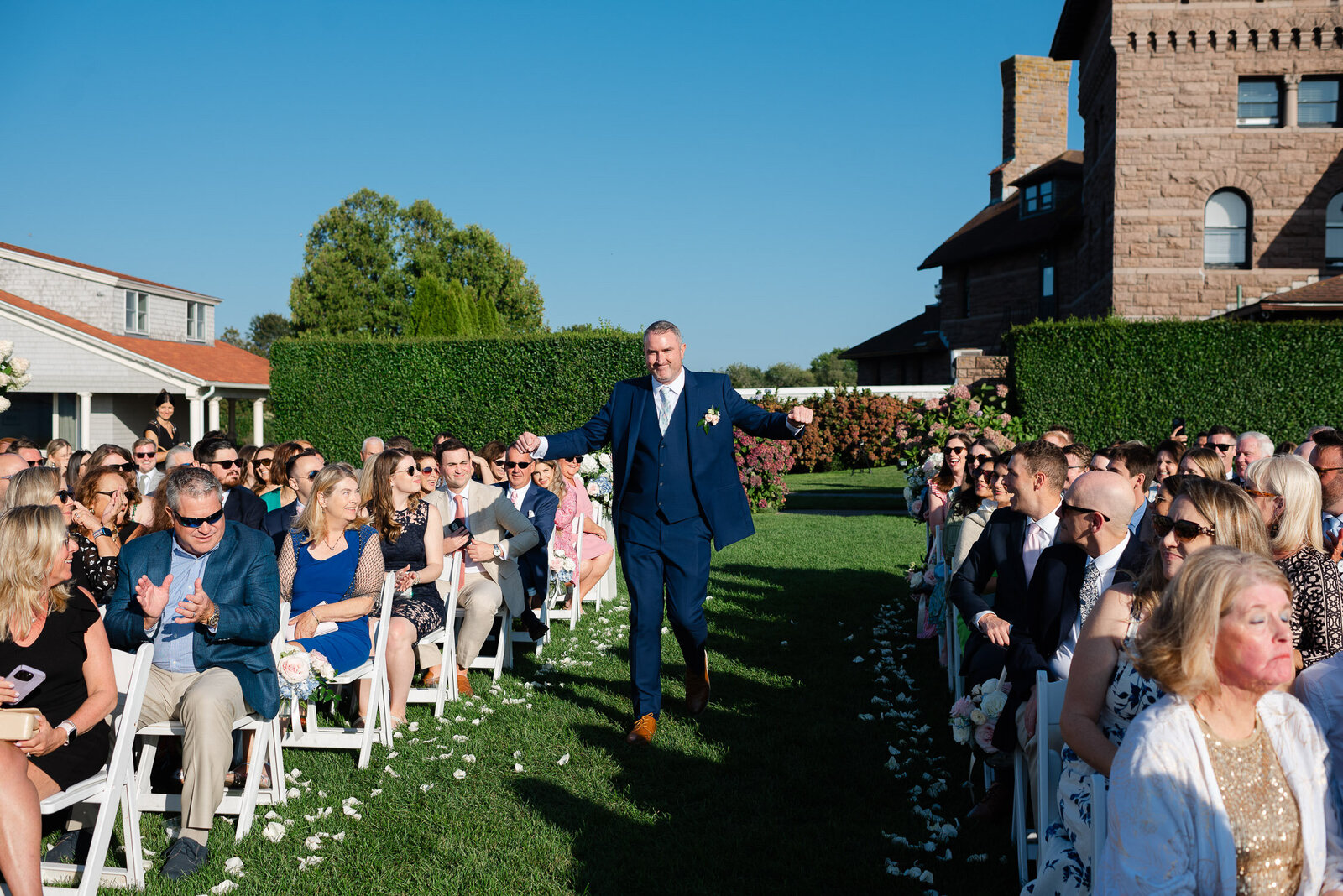 groom down aisle happy