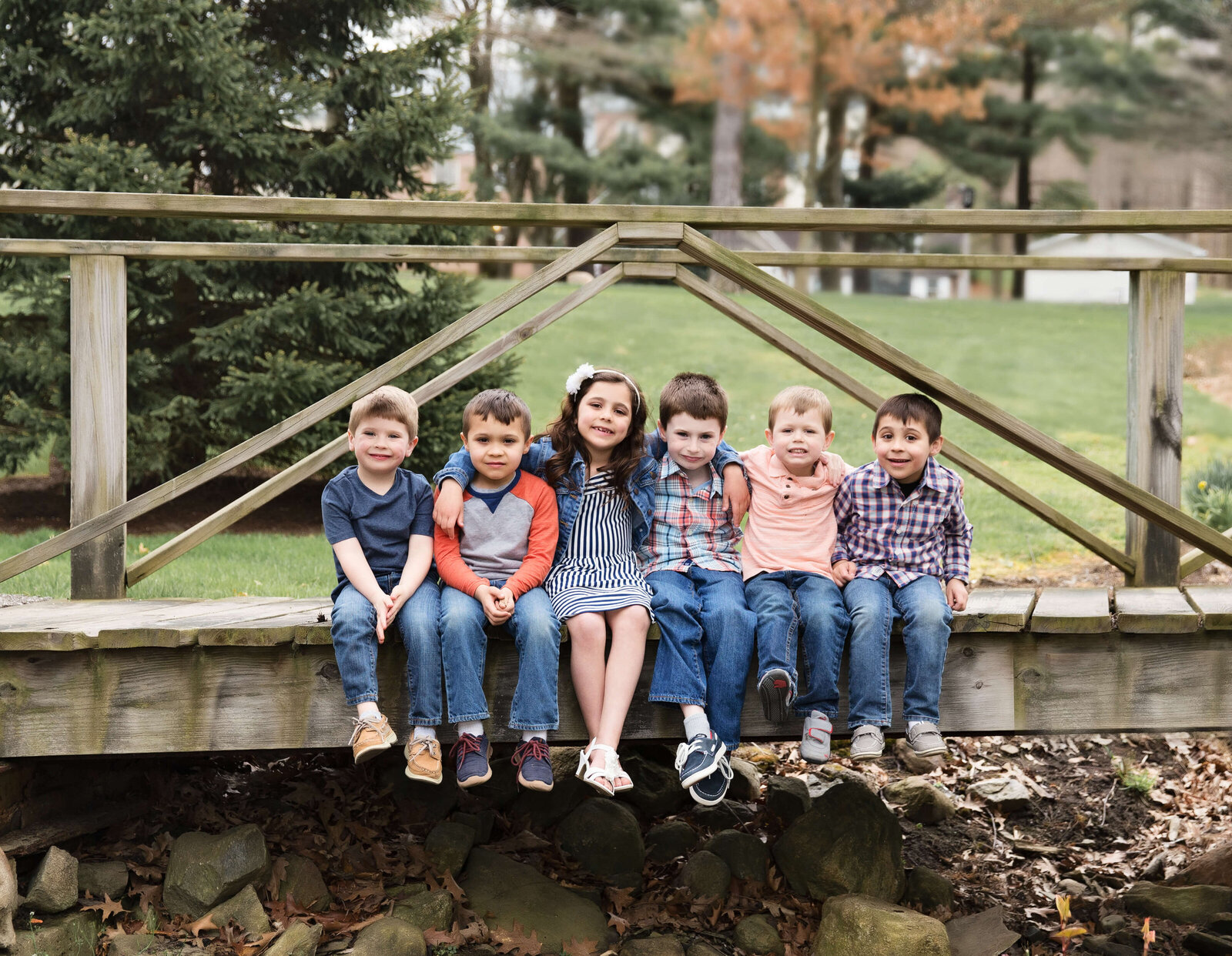 Portrait of cousins sitting on a bridge on Penn State Behrend campus