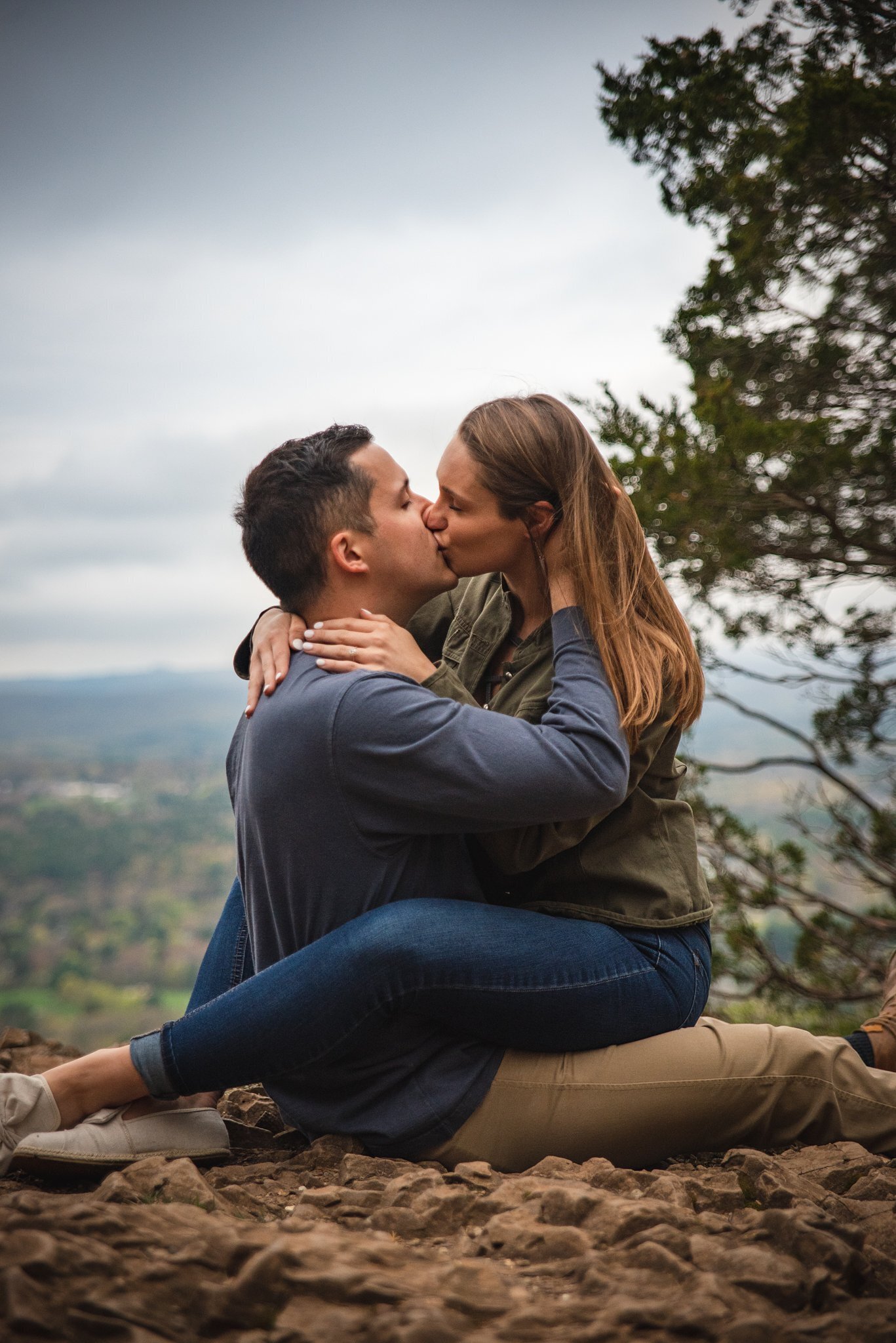 couple kissing on a cliff