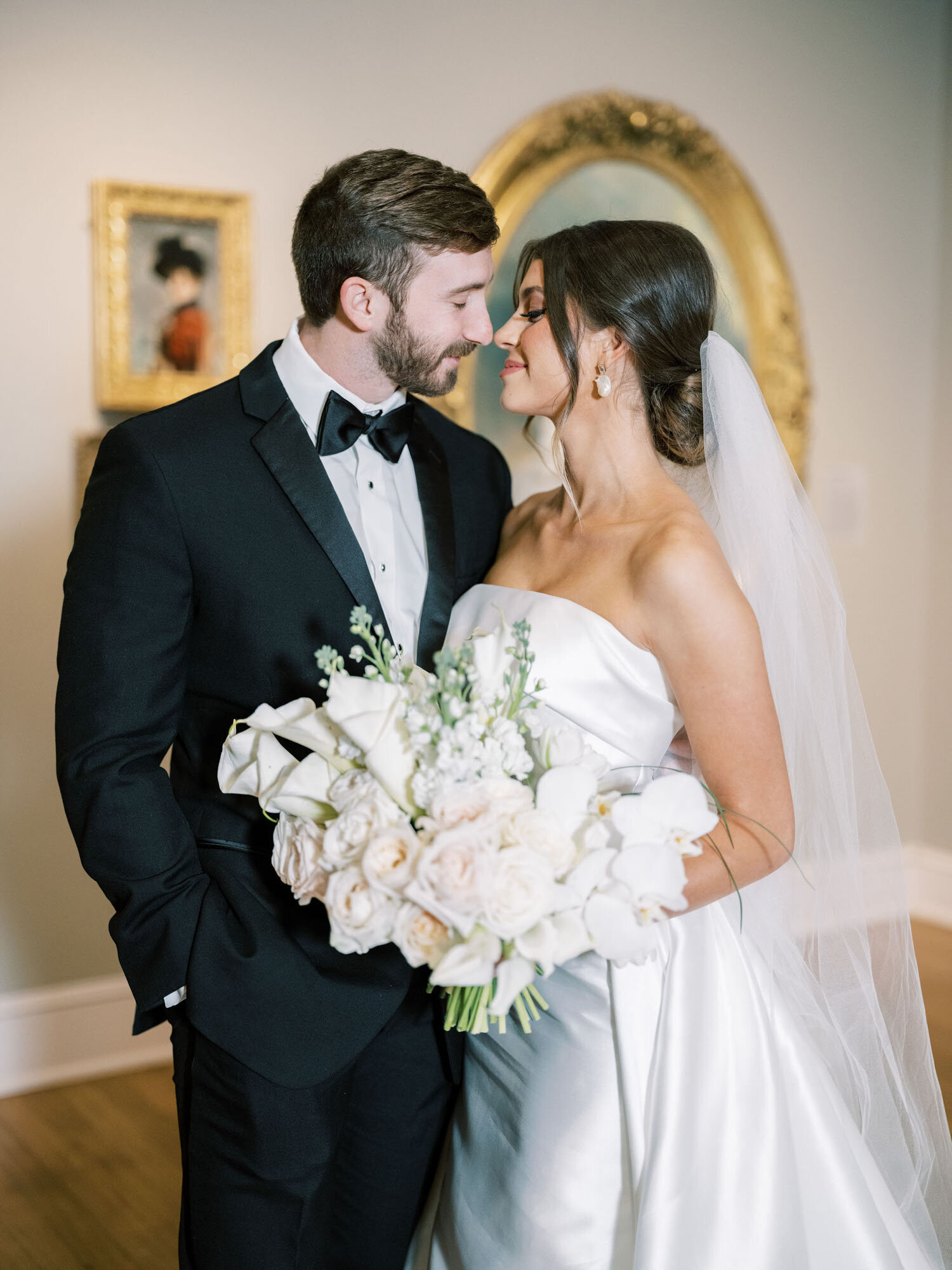 bride and groom at luxury wedding in New Orleans holding bouquet