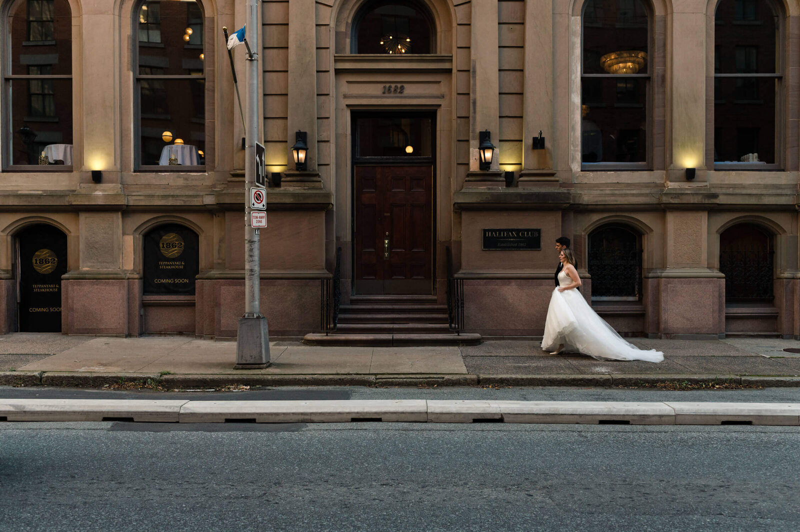 Bride walking outside the Halifax Club.