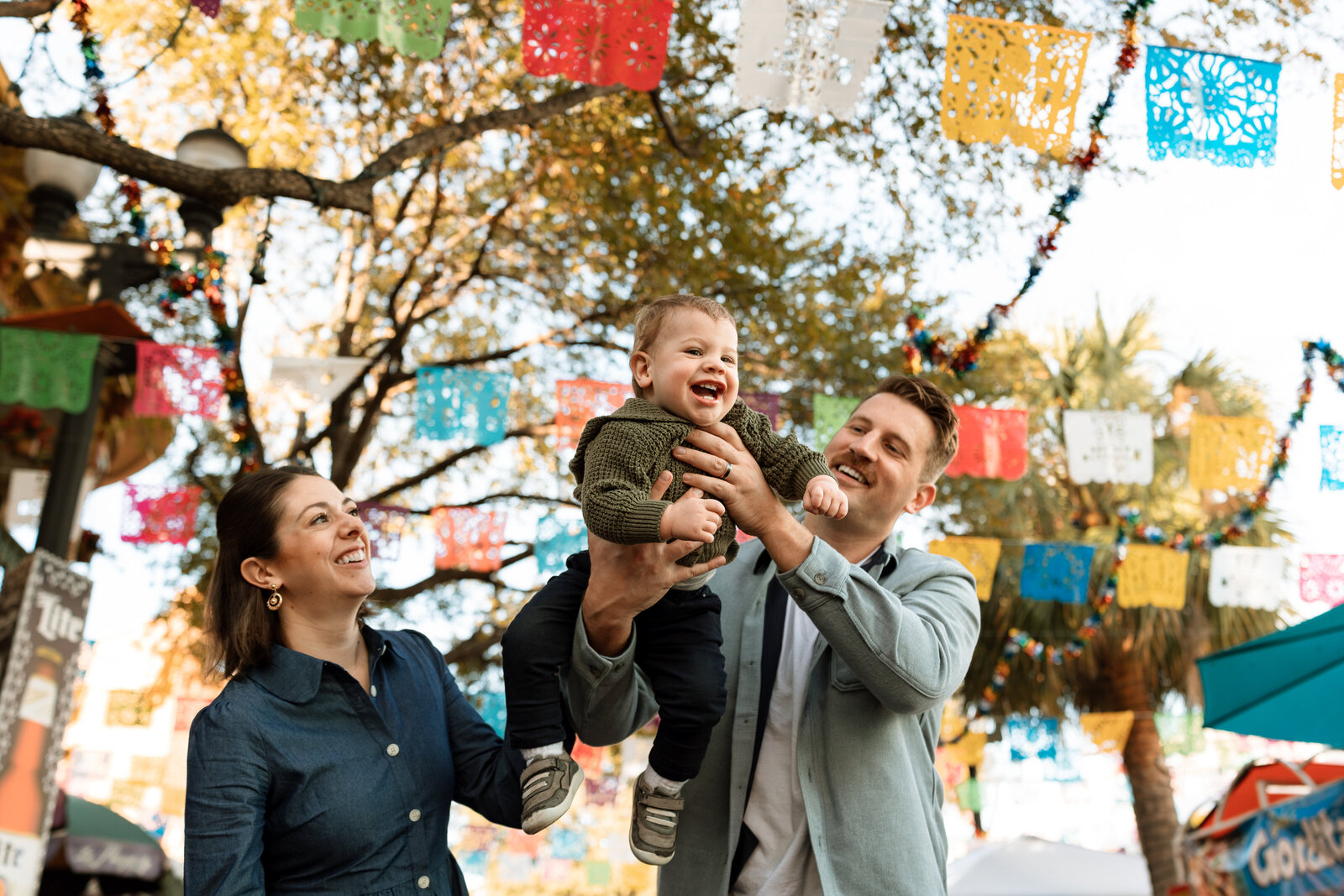 mom and dad swinging baby boy