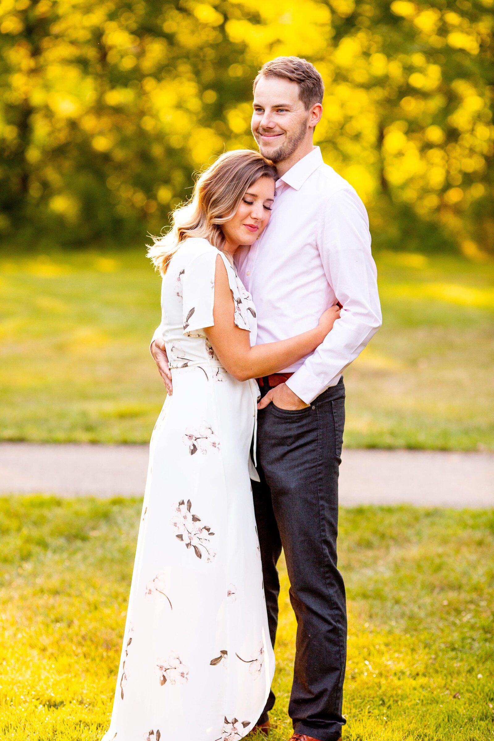 Woman rests her head on her fiance during their spring engagement session.