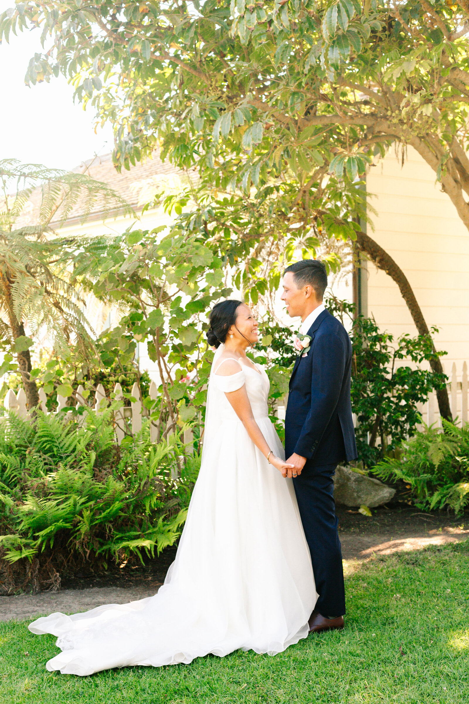 A newlywed couple holds hands after their wedding ceremony in San Pedro, Ca.