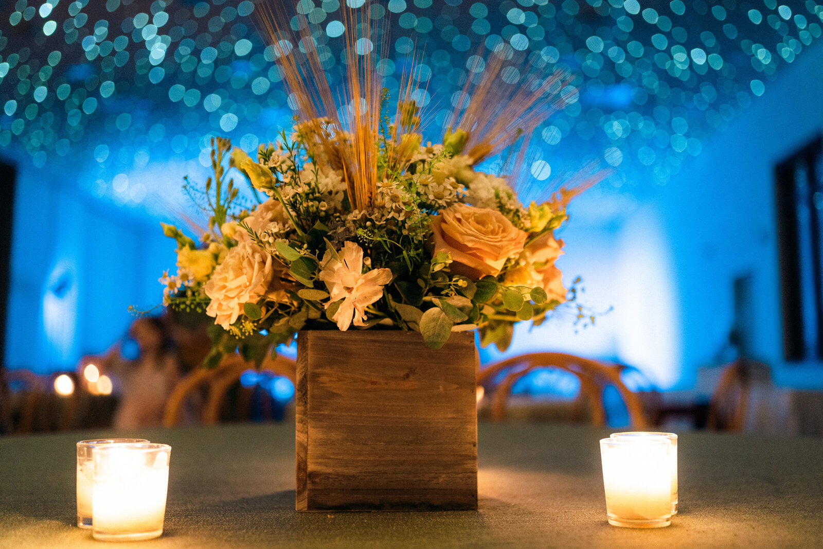 Floral arrangement  in candlelight under starry sky