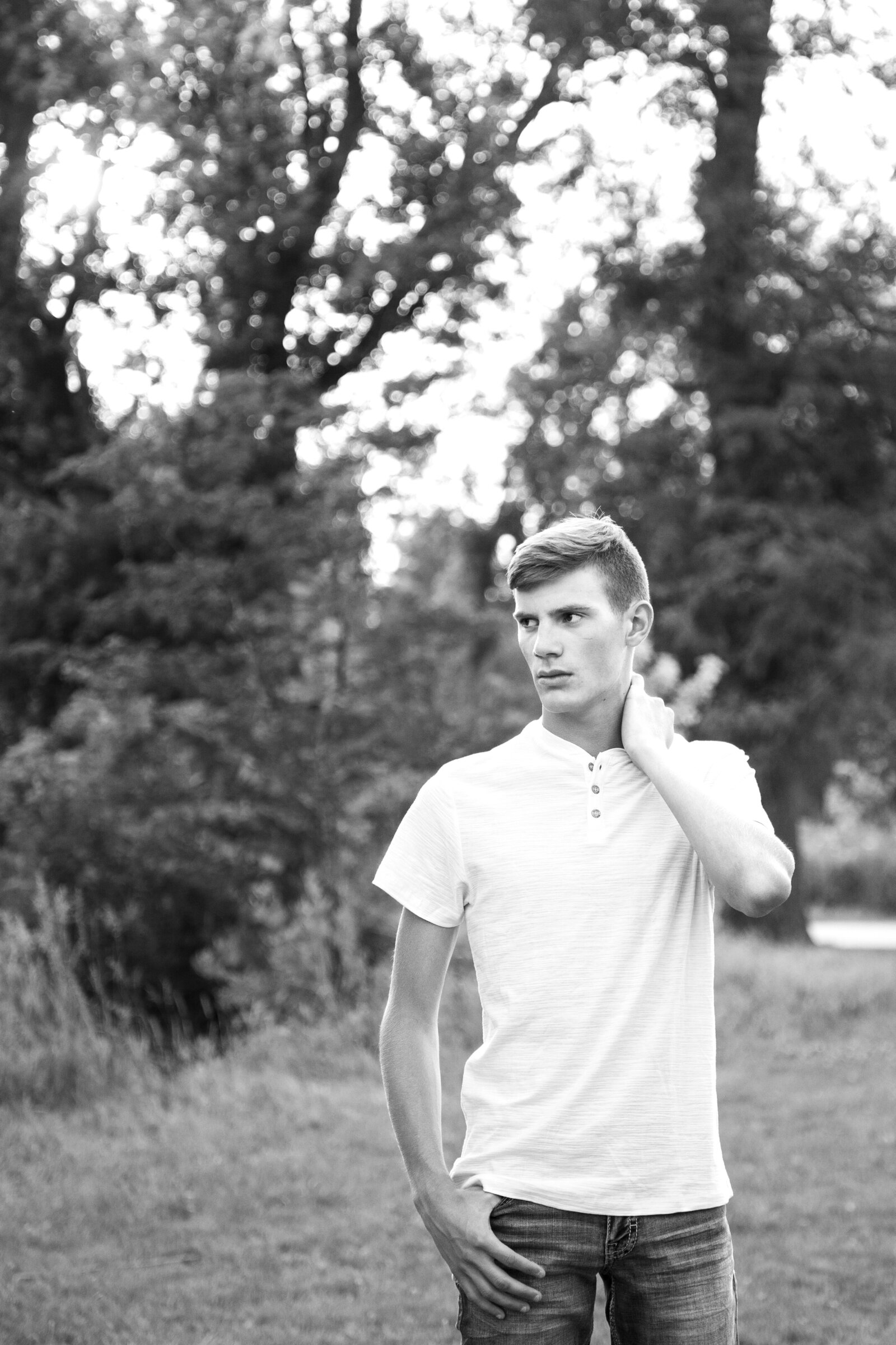 Black and white of senior boy looking off to the side.