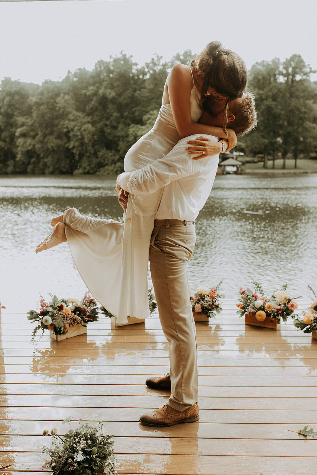 bride and groom kiss by water