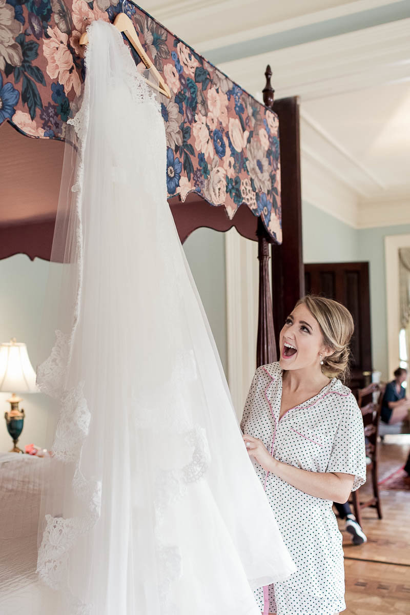 Bride gets wedding dress hanging from bed, John Rutledge House Inn, Charleston, South Carolina
