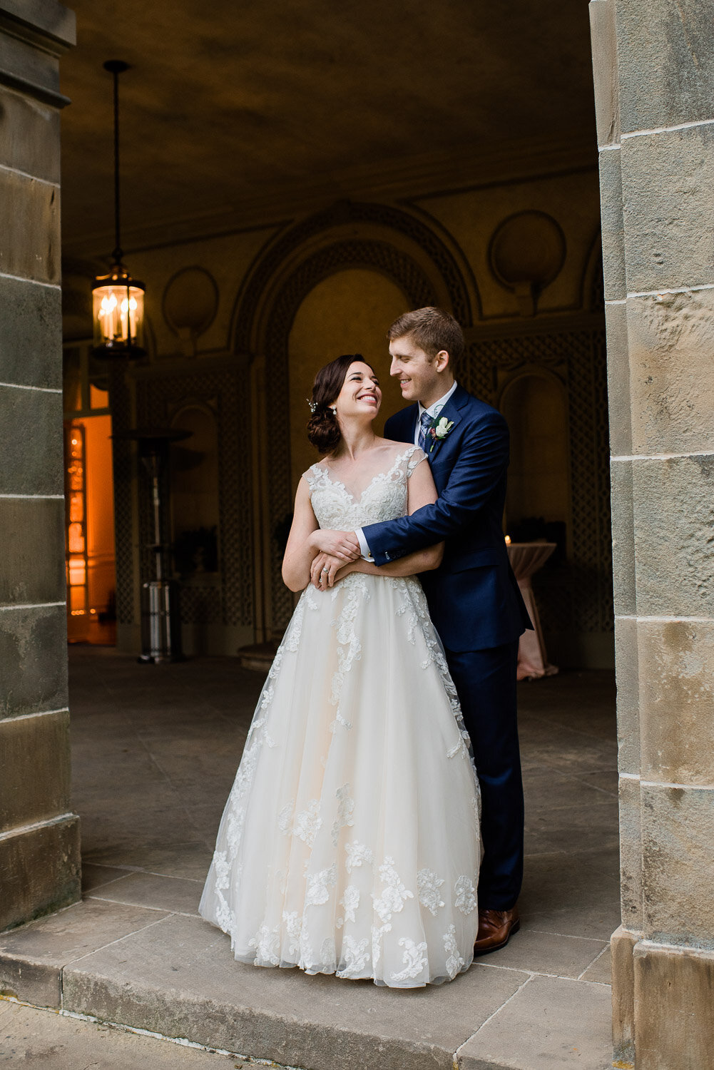 bride and groom embrace in archway