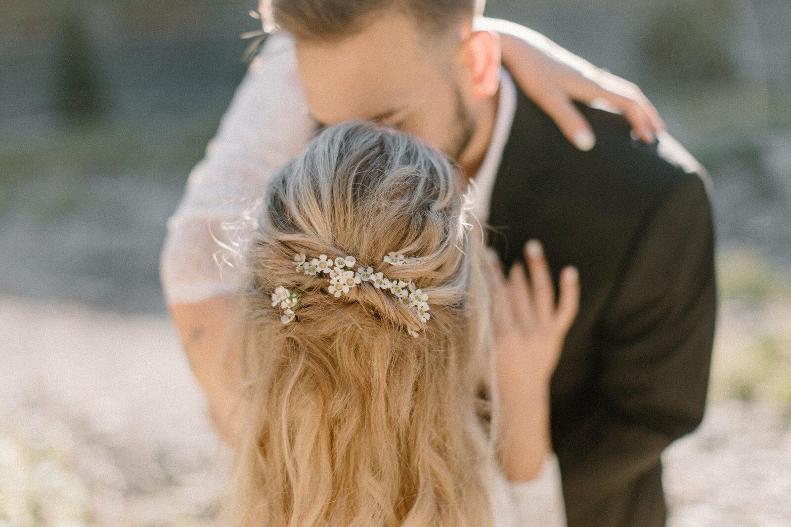 groom dipping bride with flowers in her hair