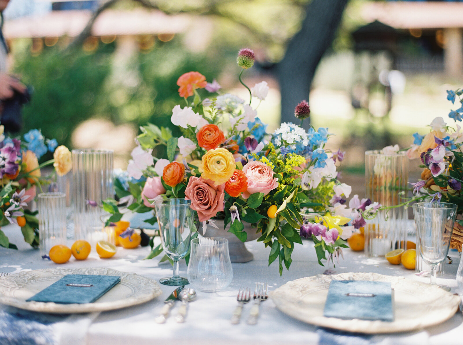 Colorful wedding tablescape featuring vibrant flowers and elegant settings, captured on film by Morgan Alysse, Louisiana film photographer.