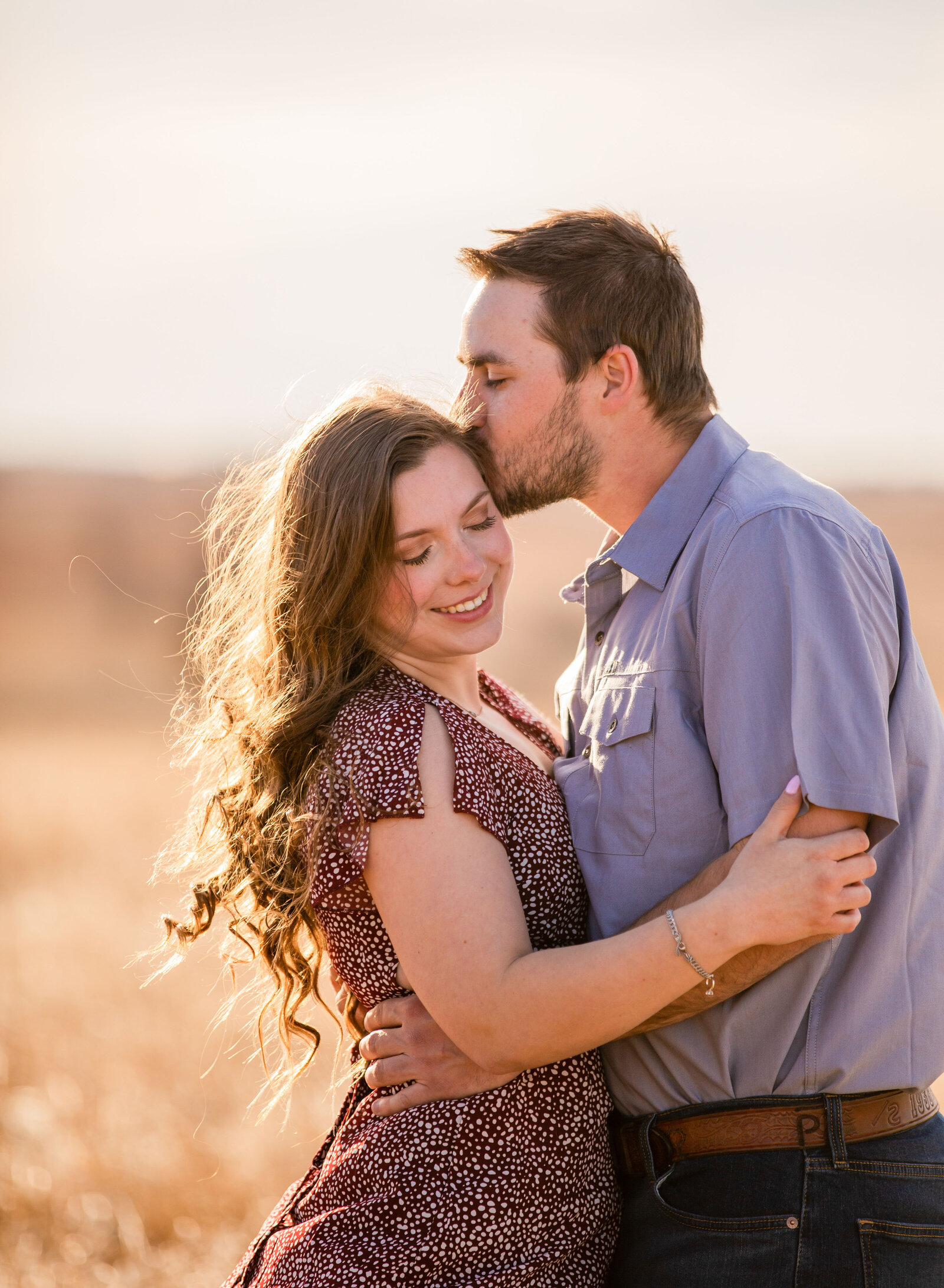 guy kissing girl's temple