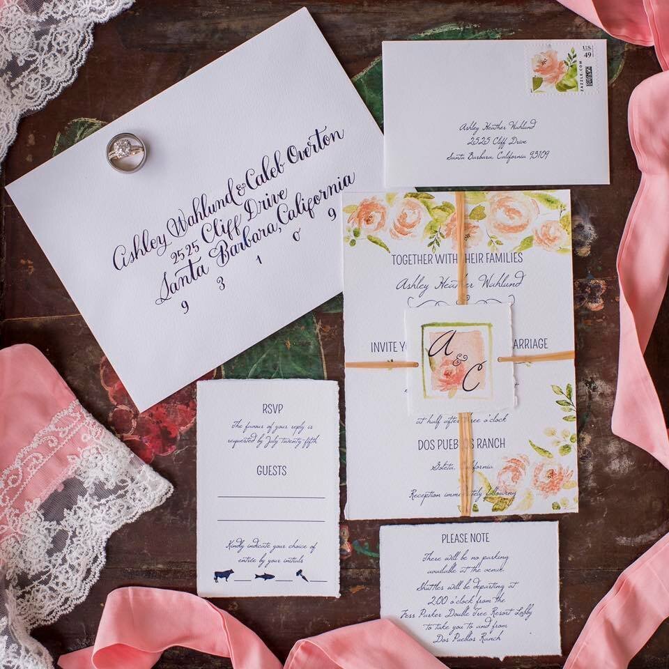 Wedding details- invitation and pink cloth beside it