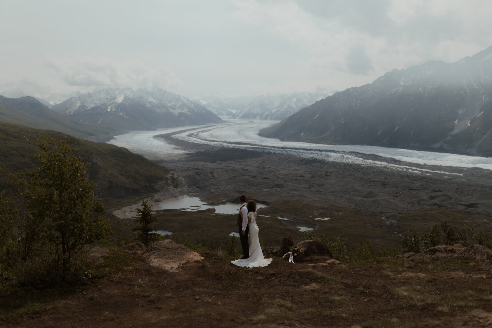 bride and groom looking at mountains