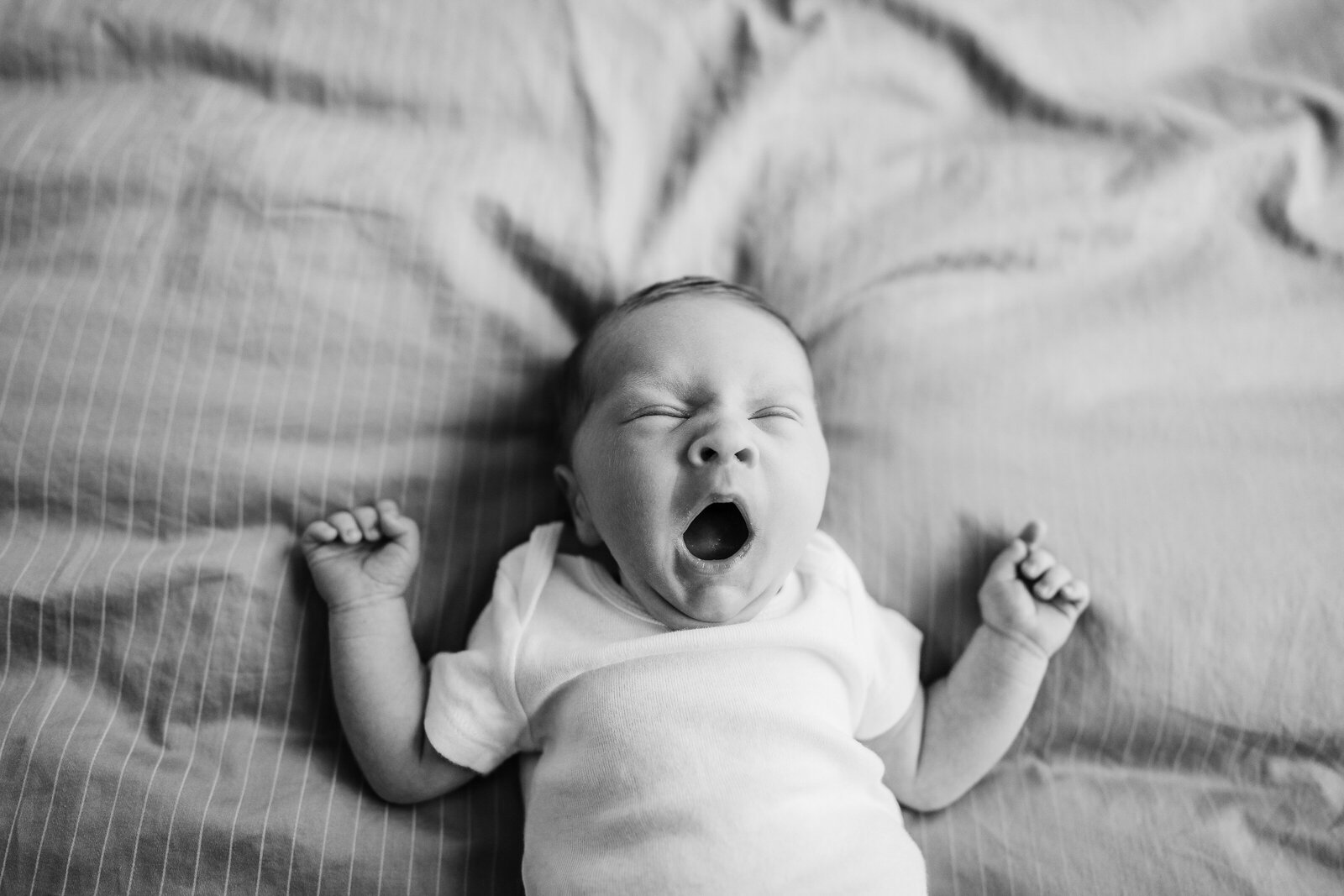 baby boy yawns during newborn photos in boston