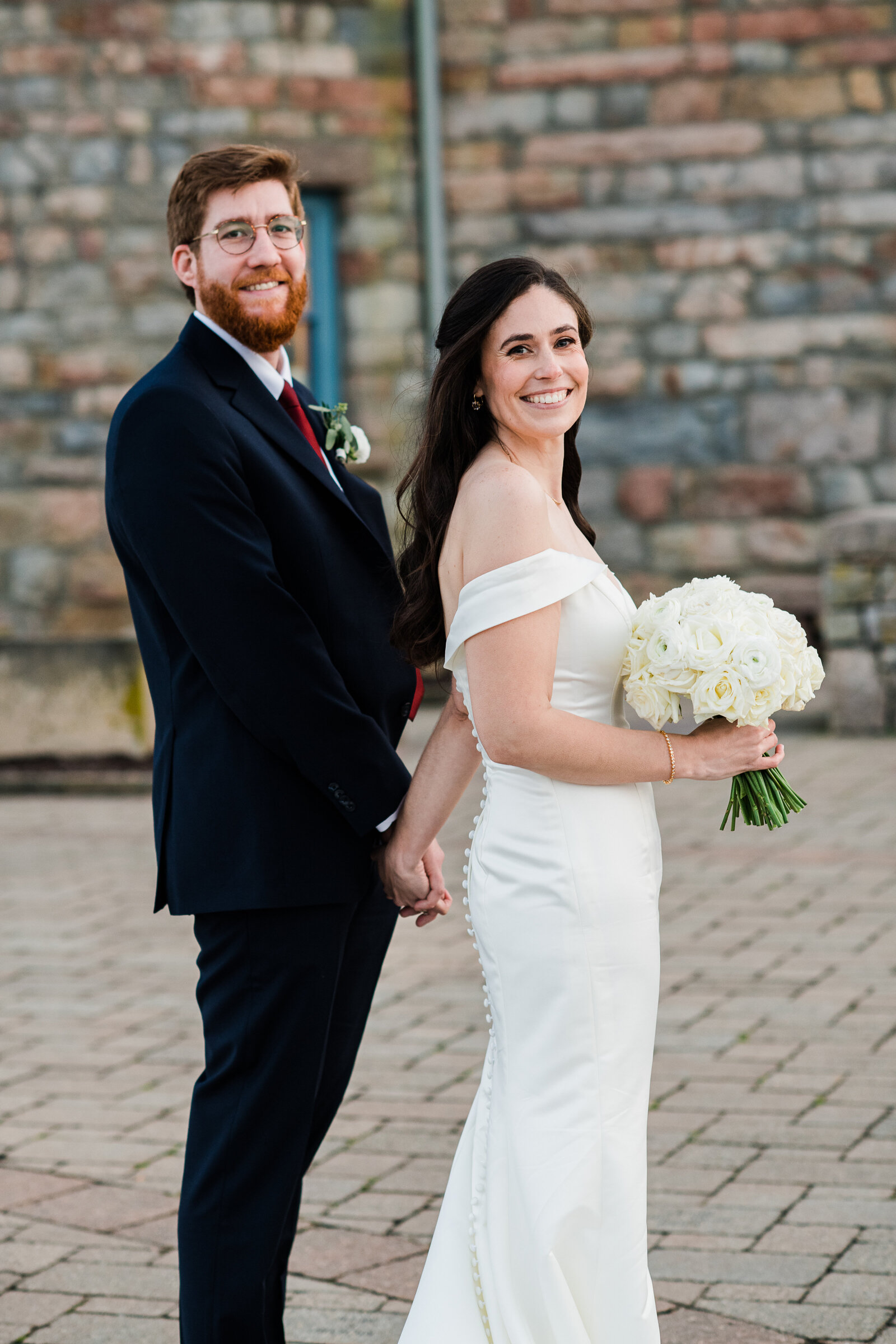 bride and groom look back and smile