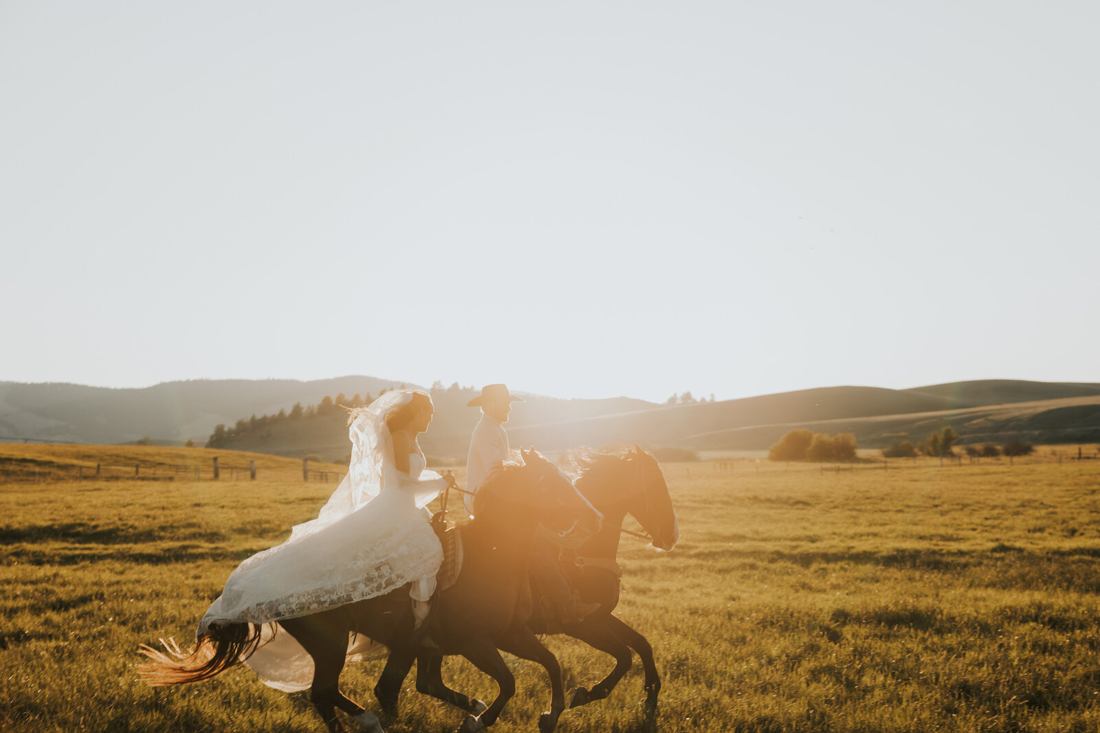 Western couple on horseback at golden hour | Idaho wedding photographer
