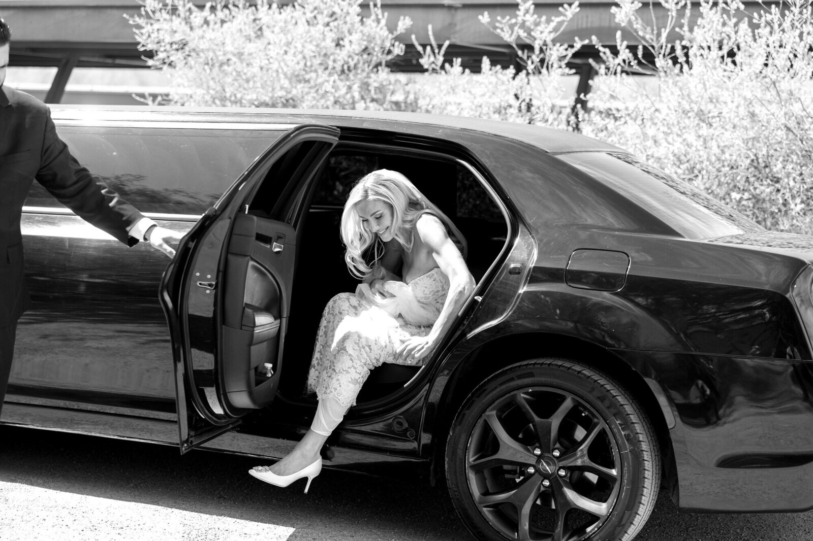 Bride getting out of limo at El Chorro in Paradise Valley, Arizona