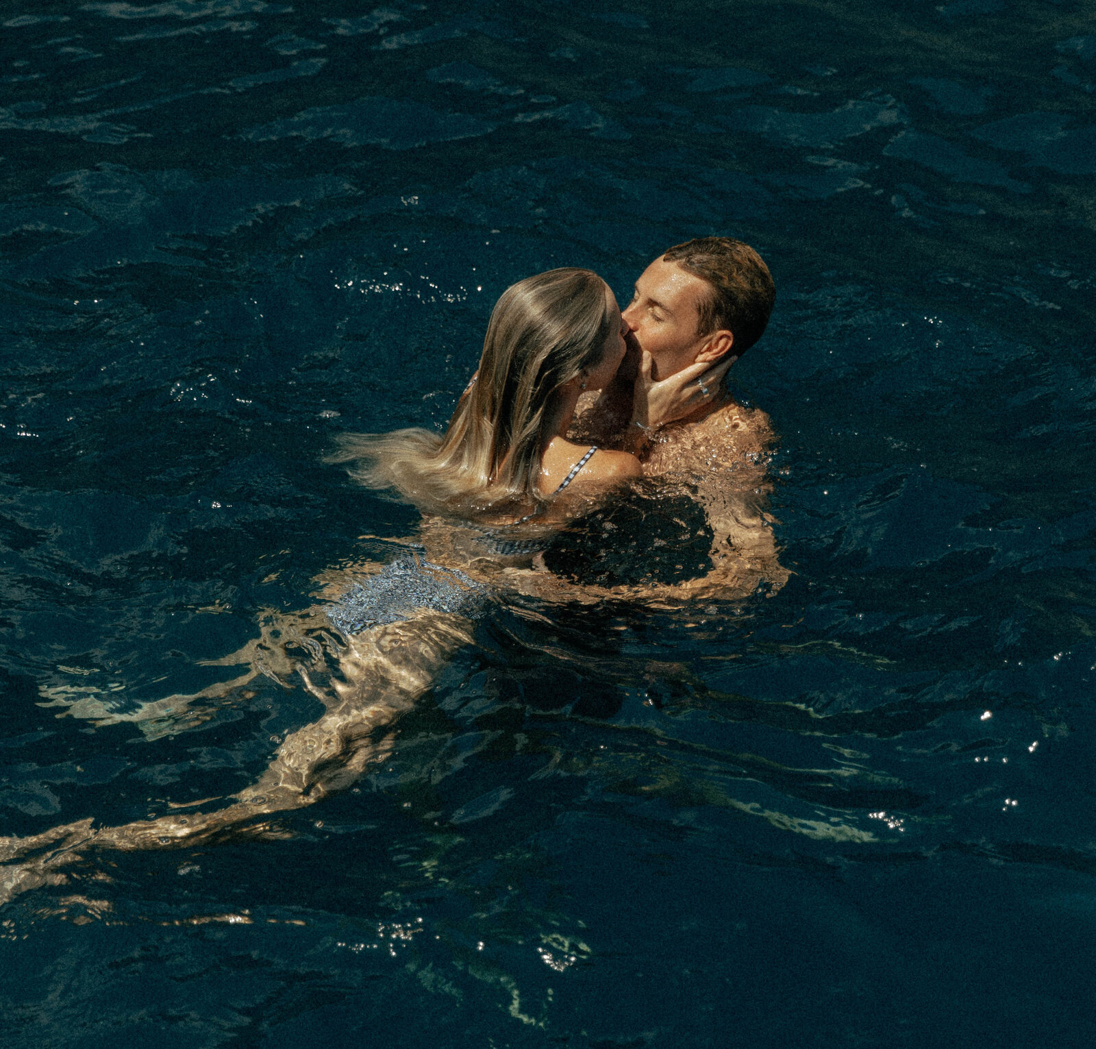 A couple together during a romantic photography session in a scenic outdoor location, with soft natural lighting